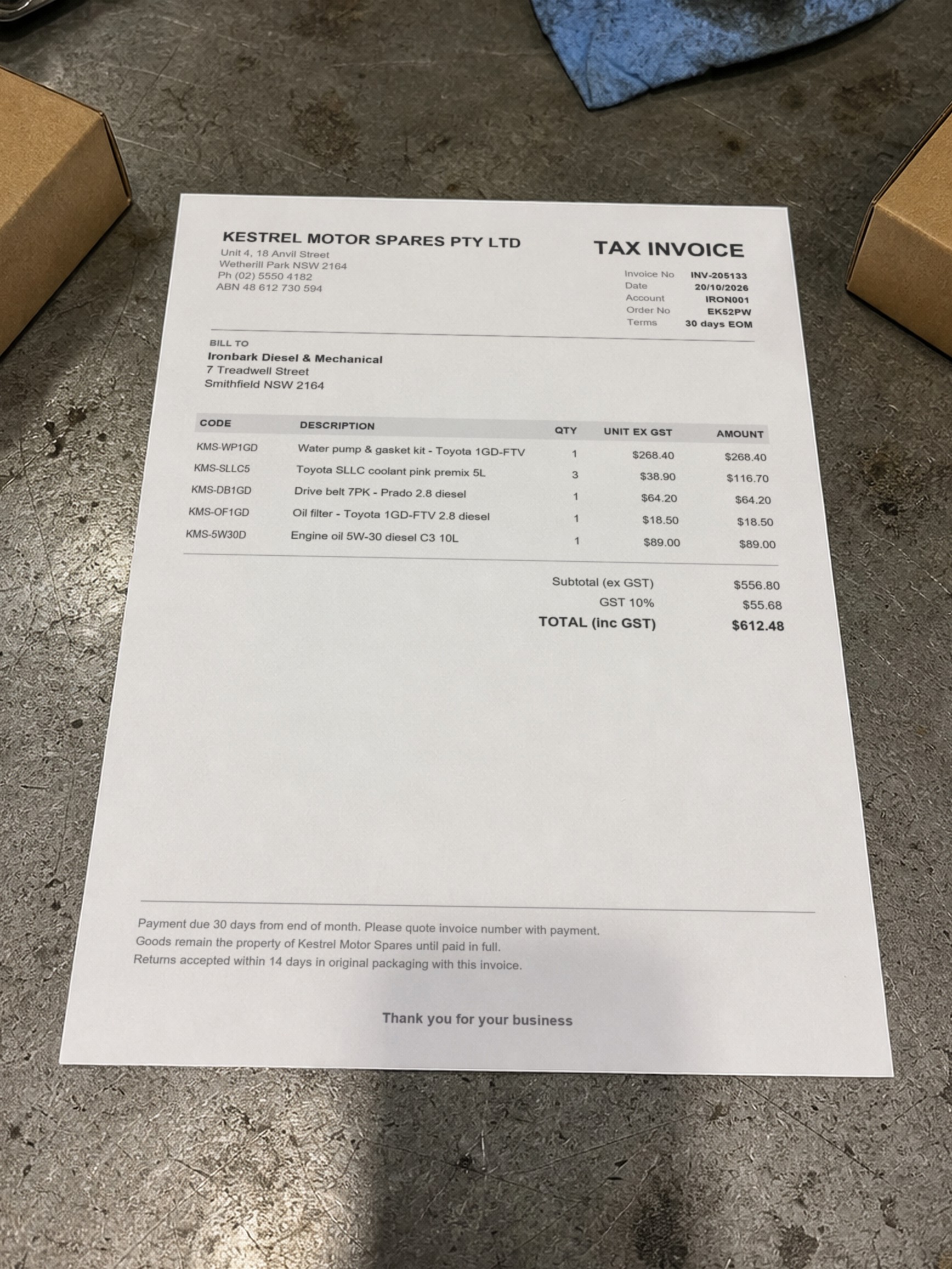 A printed supplier invoice on a workbench