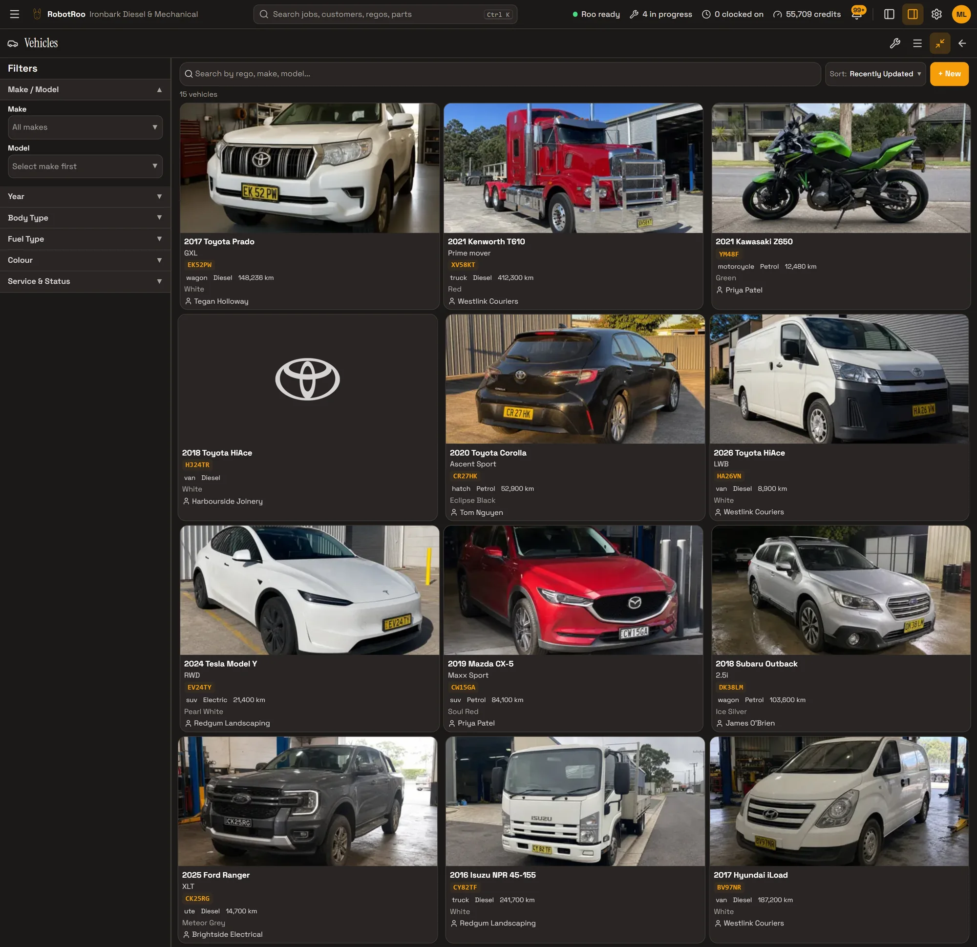 RobotRoo on a computer: the Vehicles screen with filters for make and model, year, body type, fuel type, colour and service and status, and vehicle cards with photos: a Toyota Prado, a red Kenworth T610 prime mover, a Kawasaki Z650 motorcycle, a Toyota HiAce without a photo showing the Toyota logo, a Toyota Corolla, a 2026 Toyota HiAce, a Tesla Model Y, a Mazda CX-5, a Subaru Outback, a 2025 Ford Ranger, an Isuzu NPR truck and a Hyundai iLoad